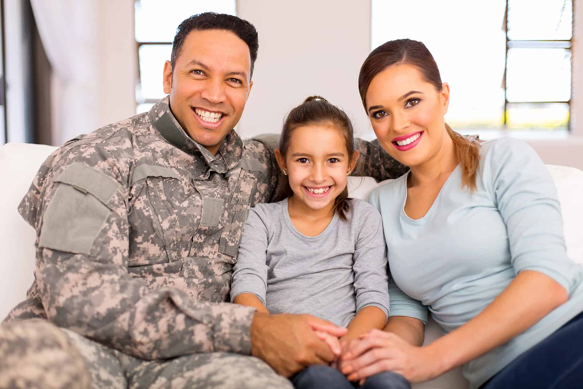 Young military family sitting on couch