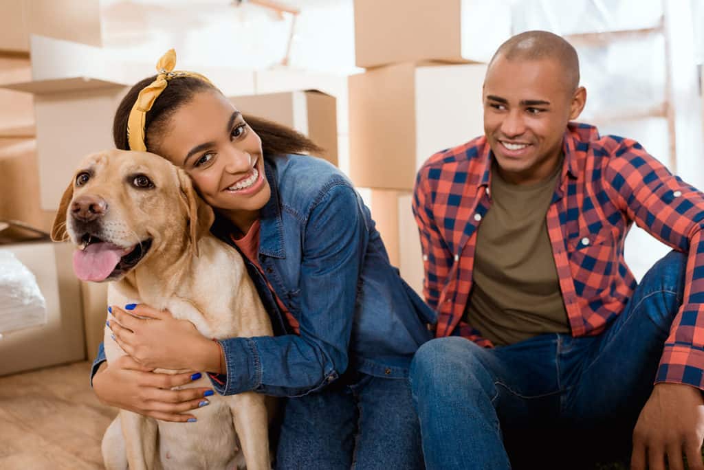 Happy African American Family Moving Into Home